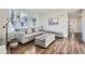 Inviting living room with a gray sofa, ottoman, and lots of natural light from the large window at 4385 Carr St, Wheat Ridge, CO 80033