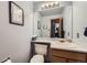 Powder room features a white countertop, a decorative mirror, and painted walls at 5455 W 112Th Pl, Westminster, CO 80020