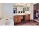 Bright bathroom featuring a double vanity, tub, and modern fixtures at 5455 W 112Th Pl, Westminster, CO 80020