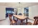 Traditional dining room features a wooden table, elegant chandelier, and a view into the living area at 5455 W 112Th Pl, Westminster, CO 80020