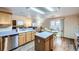 Functional kitchen with wood cabinets, central island, and a breakfast nook leading to the outdoors at 5455 W 112Th Pl, Westminster, CO 80020