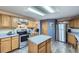Bright kitchen features an island, stainless steel appliances, and plenty of cabinet space at 5455 W 112Th Pl, Westminster, CO 80020