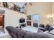Open living room features a vaulted ceiling, a fireplace, and large comfortable sofas at 5455 W 112Th Pl, Westminster, CO 80020
