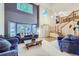 Elegant living room with large windows, wood floors, a staircase, and comfortable seating at 5455 W 112Th Pl, Westminster, CO 80020
