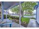 Covered front porch features a seating area, manicured bushes, and a clear view of the peaceful neighborhood at 5455 W 112Th Pl, Westminster, CO 80020