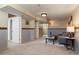 Open basement featuring textured walls, neutral carpet, and a lounge area at 653 S Main St, Elizabeth, CO 80107
