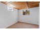 Basement bedroom featuring a window, beige carpet, and white trim at 653 S Main St, Elizabeth, CO 80107