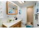 Bathroom featuring a shower stall, toilet, double vanity and wall art at 653 S Main St, Elizabeth, CO 80107