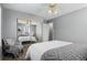 Bright bedroom featuring neutral walls, sliding mirror closet and ceiling fan with light fixture at 653 S Main St, Elizabeth, CO 80107