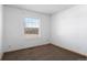 Bedroom with neutral walls, neutral carpet, one window, and white baseboard trim at 653 S Main St, Elizabeth, CO 80107