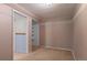 Spare bedroom with tan walls, neutral carpet, large closet and white trim at 653 S Main St, Elizabeth, CO 80107