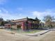 Attractive building with outdoor seating, large windows, and a mix of brick and wood paneling at 653 S Main St, Elizabeth, CO 80107