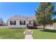 Cozy home with well-maintained lawn, front porch, and mature tree offering shade and privacy at 653 S Main St, Elizabeth, CO 80107
