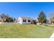 Quaint home with a picket fence, small porch, and well-manicured lawn creating a welcoming entrance at 653 S Main St, Elizabeth, CO 80107