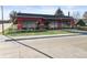 Eye-catching building with large windows and outdoor seating under umbrellas along a wide sidewalk at 653 S Main St, Elizabeth, CO 80107