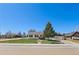 Well-kept home with a charming front porch and large tree providing shade and curb appeal at 653 S Main St, Elizabeth, CO 80107