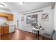 Bright kitchen and dining area featuring wood cabinets and hardwood floors at 653 S Main St, Elizabeth, CO 80107