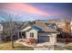 House exterior showcasing stone accents and a two-car garage at 9821 S Flower Ct, Littleton, CO 80127