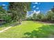 Expansive backyard with lush lawn, mature trees, offering a serene outdoor space at 1552 W Caley Ave, Littleton, CO 80120