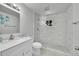 Modern bathroom with glass-enclosed shower, marble tile, and sleek vanity at 1552 W Caley Ave, Littleton, CO 80120