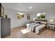 Sunny bedroom featuring hardwood floors, closet space, and natural light at 1552 W Caley Ave, Littleton, CO 80120