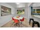 Cozy dining room featuring a retro table set, large window, and laminate flooring with blue accents at 1552 W Caley Ave, Littleton, CO 80120