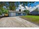 Charming blue single-story home with a well-manicured lawn and a one car garage with a long driveway at 1552 W Caley Ave, Littleton, CO 80120