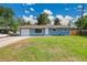 Charming blue single-story home with a well-manicured lawn and a one car garage, bathed in sunlight at 1552 W Caley Ave, Littleton, CO 80120