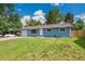 Charming blue single-story home with a well-manicured lawn and a one car garage with cars in the driveway at 1552 W Caley Ave, Littleton, CO 80120