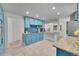 Bright kitchen with blue cabinets, granite countertops, tile backsplash and stainless steel appliances at 1552 W Caley Ave, Littleton, CO 80120