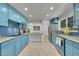 Spacious kitchen with granite counters, blue backsplash, modern appliances, and tile flooring at 1552 W Caley Ave, Littleton, CO 80120