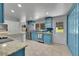 Sunlit kitchen with blue cabinets, stainless steel appliances, and access to the backyard at 1552 W Caley Ave, Littleton, CO 80120
