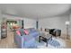 Bright living room featuring a plush sectional sofa, contemporary decor, laminate flooring, and an open layout at 1552 W Caley Ave, Littleton, CO 80120