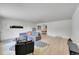 Bright living room featuring a plush sectional sofa, contemporary decor, and laminate flooring at 1552 W Caley Ave, Littleton, CO 80120