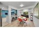 Open-concept living space with a dining room connected to a modern kitchen and spacious living room at 1552 W Caley Ave, Littleton, CO 80120