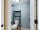 Small half bathroom with toilet and shelving unit at 14000 E Linvale Pl # 110, Aurora, CO 80014