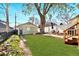 Spacious backyard with a large patio area, tree, and garage at 3337 Decatur St, Denver, CO 80211