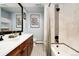 Modern bathroom features double sinks, stylish tile, and a shower-tub combination at 3337 Decatur St, Denver, CO 80211