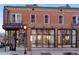 Exterior view of Kumoya Japanese Kitchen, featuring a vintage red brick facade and large windows at 3337 Decatur St, Denver, CO 80211
