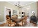 Bright dining room with a classic chandelier and warm wood floors at 3337 Decatur St, Denver, CO 80211