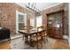 Charming dining room with exposed brick wall, chandelier, and hardwood floors at 3337 Decatur St, Denver, CO 80211
