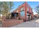 A red brick building features the Restaurant Taqueria Patzcuaro sign, with a black awning and outdoor seating area at 3337 Decatur St, Denver, CO 80211