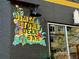 Eye-catching mural advertising Dime Store Deli Bar on a dark brick wall with window reflections at 3337 Decatur St, Denver, CO 80211