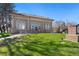 Beaux-Arts style brick building with a red tiled roof, arched windows, and a well-manicured green lawn at 3337 Decatur St, Denver, CO 80211