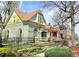 Charming two-story home with a quaint front porch, colorful vintage paint, and lovely landscaping at 3337 Decatur St, Denver, CO 80211