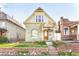 Beautiful exterior view of a quaint home with inviting front porch, landscaped yard, and classic architectural design at 3337 Decatur St, Denver, CO 80211