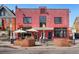 Red brick building showcasing the Park Burger restaurant, highlighted by outdoor seating and eye-catching signage at 3337 Decatur St, Denver, CO 80211