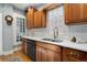 Kitchen featuring white countertops, a stainless steel dishwasher, and wood cabinets at 3337 Decatur St, Denver, CO 80211