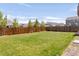 Large, well-maintained backyard featuring a full lawn and wood fence, great for outdoor enjoyment at 7678 S Old Hammer Way, Aurora, CO 80016