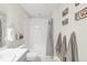 Bright bathroom featuring a shower-tub combo, complemented by stylish decor and coordinated towels at 7678 S Old Hammer Way, Aurora, CO 80016